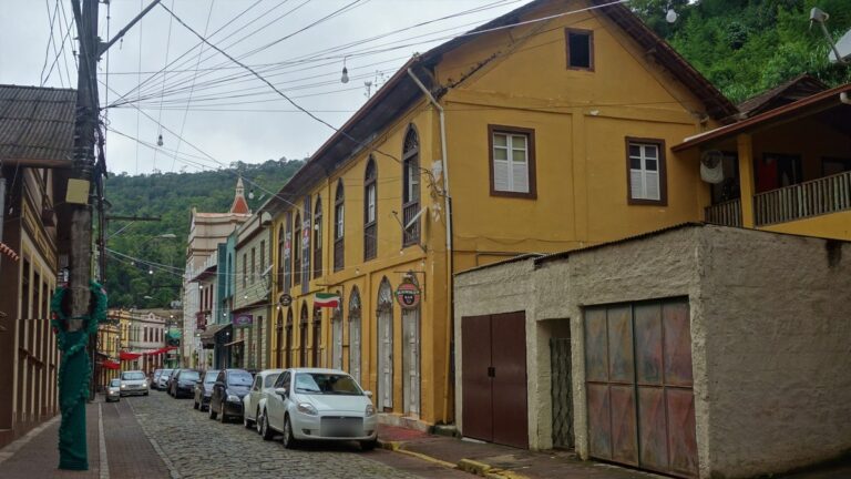 Rua do centro histórico de Santa Teresa - ES, com casario de duas águas e mata atlântica ao fundo